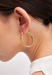 Gold hoop earrings with braided design